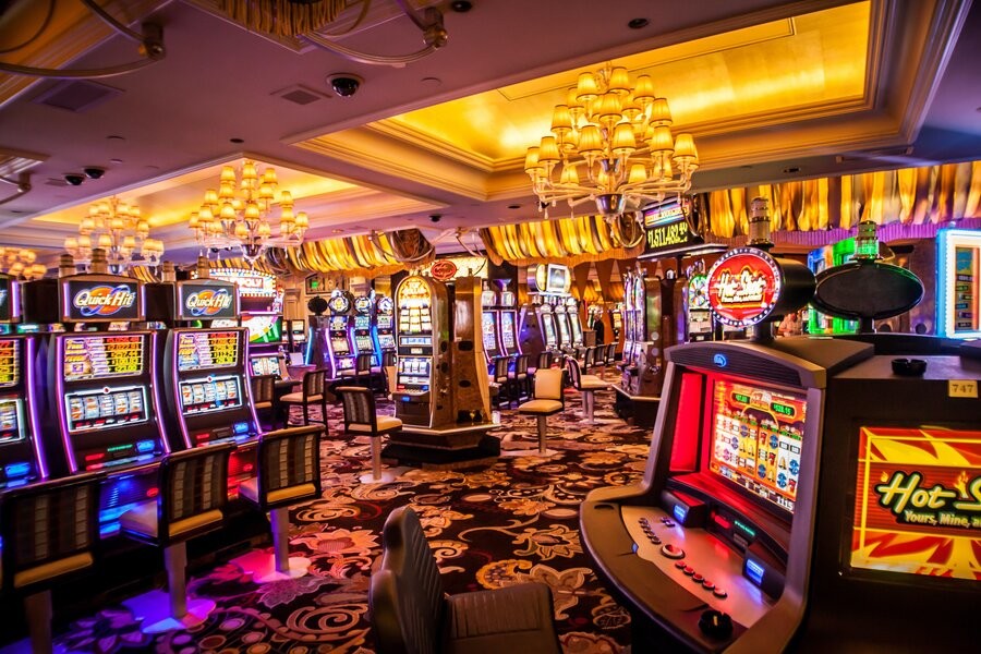 A casino floor featuring slot machines in a well-illuminated space.