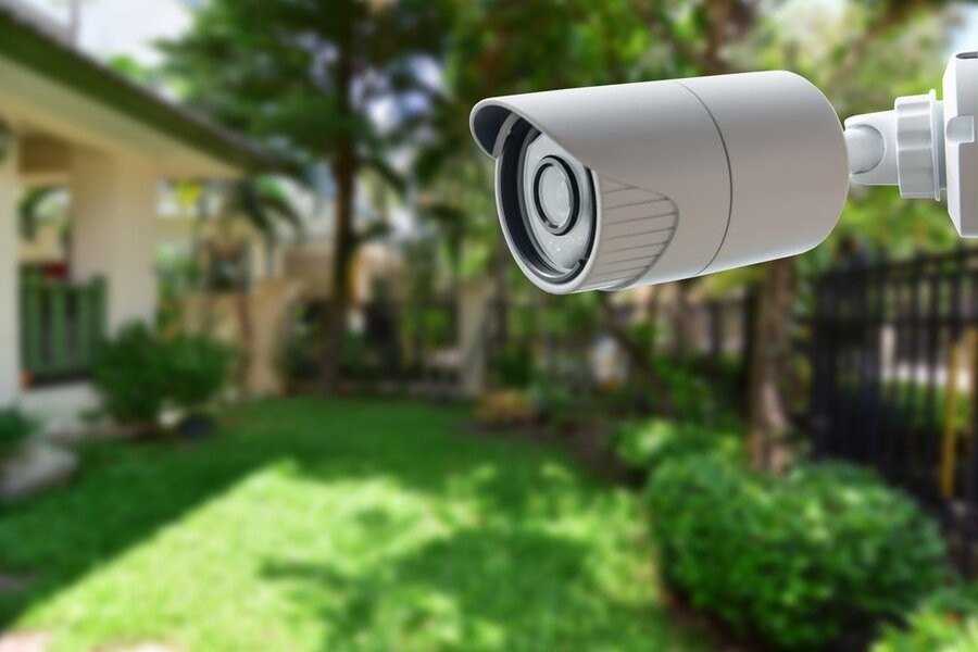 A smart home security camera above a backyard.