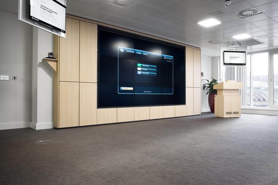 A commercial workspace featuring a video wall installation