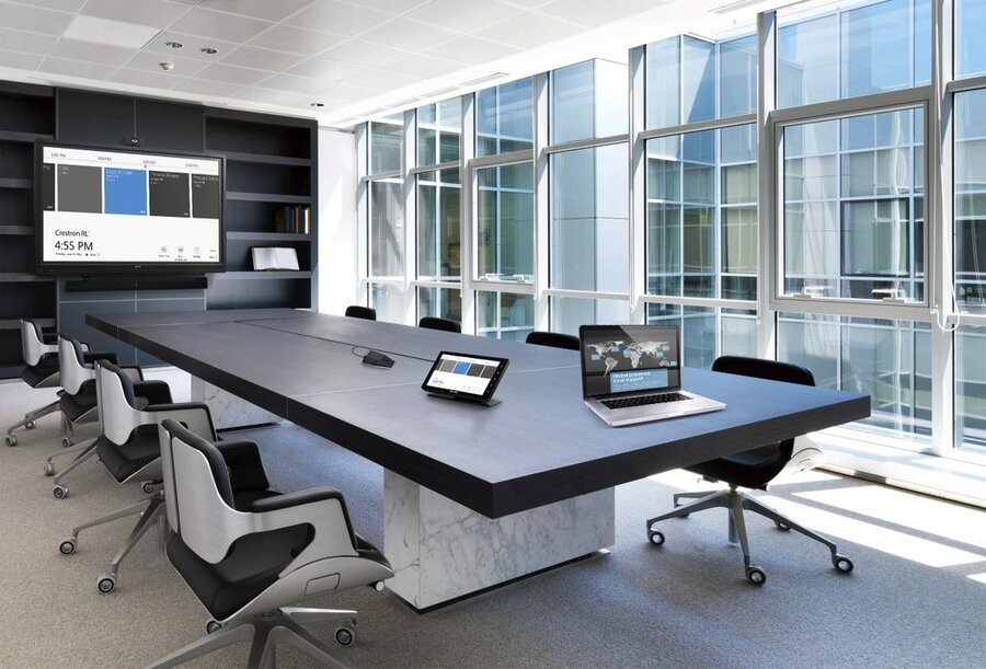 A conference room setup featuring various smart technologies from Crestron