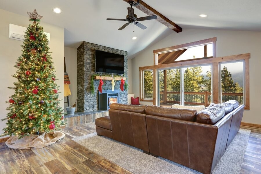 A living room space featuring smart home automation solutions and a Christmas tree and other holiday décor.